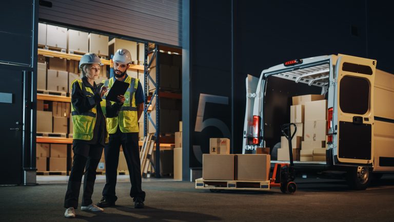 Services 7 outside logistics distributions warehouse with manager using tablet computer diverse workers loading delivery truck with cardboard boxes online orders purchases ecommerce goods scaled